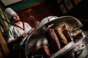 A Lawry's carver by his famous Silver Cart, ready to serve prime rib